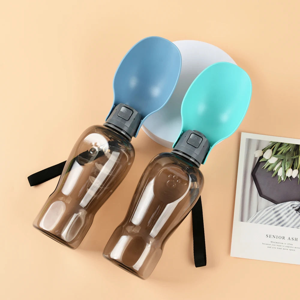 Two portable pet water bottles with blue and teal lids on beige background, GEO store product.